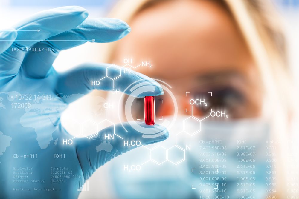 Female scientist holding a red transparent pill with futuristic scientific air interface